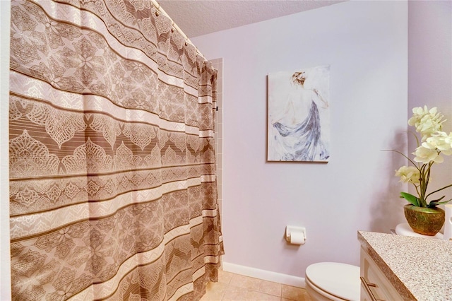 bathroom with toilet, a textured ceiling, tile patterned floors, and vanity