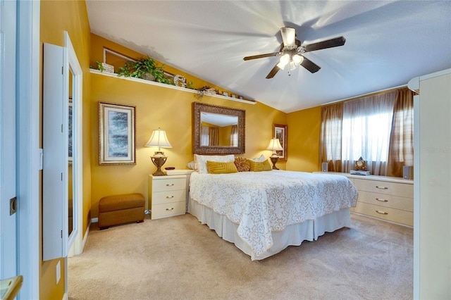 carpeted bedroom featuring ceiling fan and vaulted ceiling