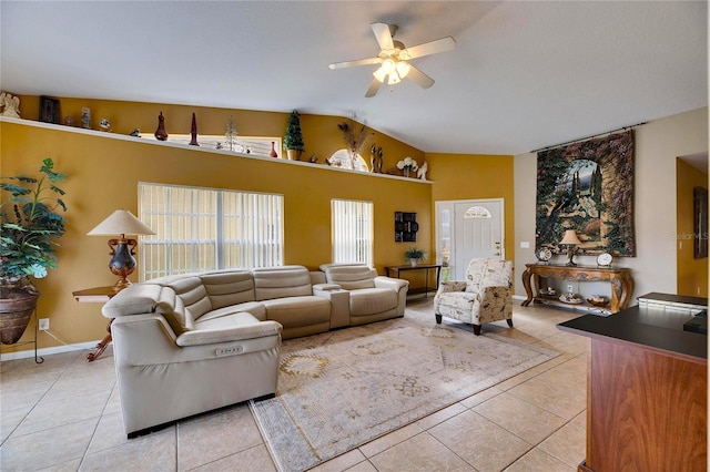 living room featuring vaulted ceiling, ceiling fan, and light tile patterned floors