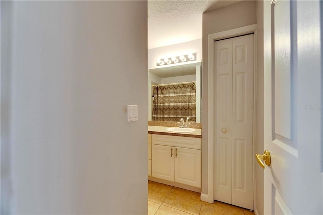 bathroom with vanity, tile patterned flooring, decorative backsplash, and curtained shower