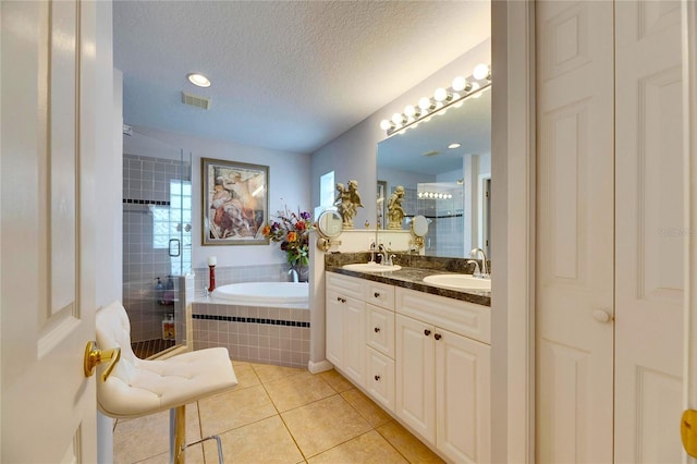 bathroom with vanity, tile patterned floors, a textured ceiling, and shower with separate bathtub