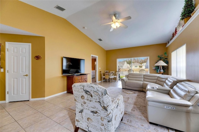 living room featuring ceiling fan, light tile patterned floors, and vaulted ceiling