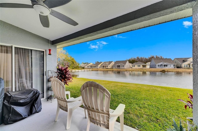 view of patio / terrace with ceiling fan, a grill, and a water view