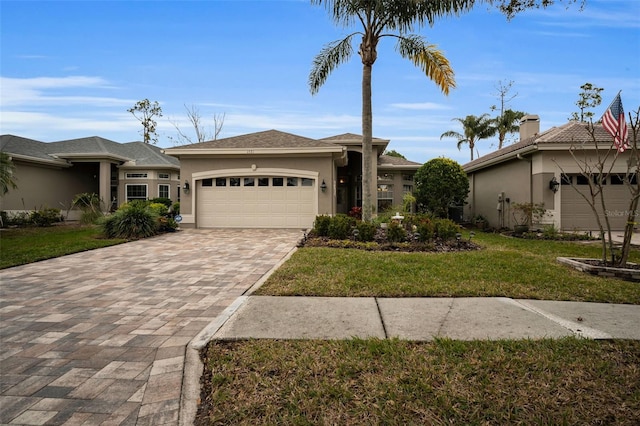 view of front of home with a garage and a front yard