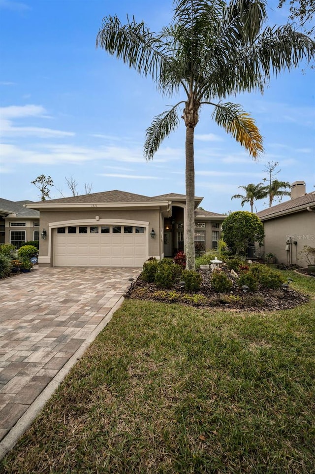 view of front of house featuring a garage and a front lawn