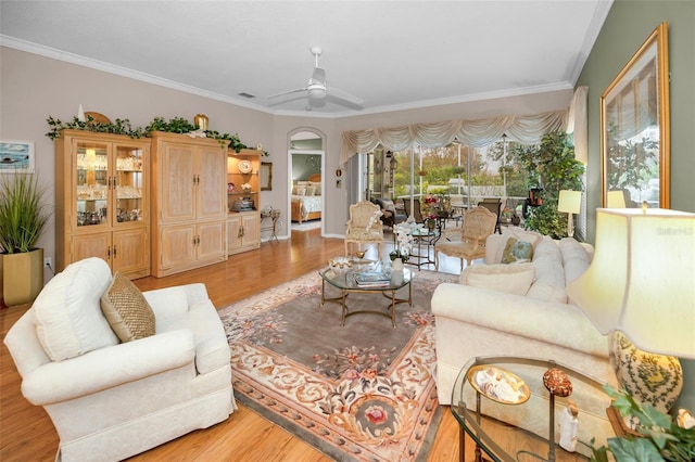 living room featuring ceiling fan, light hardwood / wood-style flooring, and ornamental molding