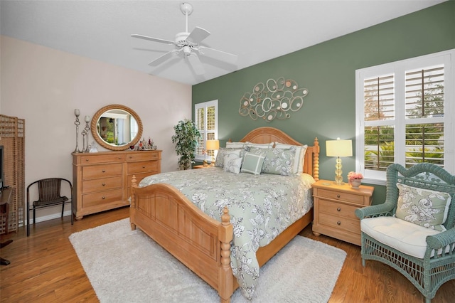 bedroom with ceiling fan and hardwood / wood-style floors