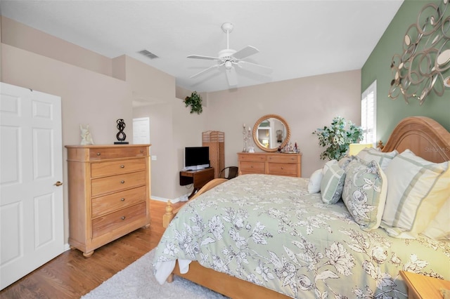 bedroom with ceiling fan and hardwood / wood-style floors