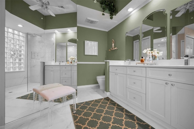 bathroom with toilet, ceiling fan, a tile shower, and vanity