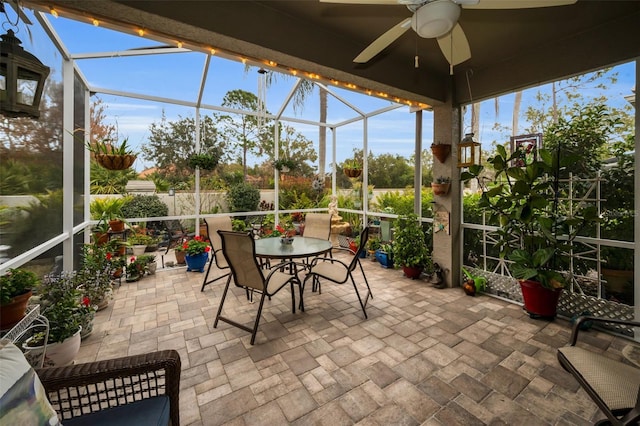 sunroom featuring ceiling fan