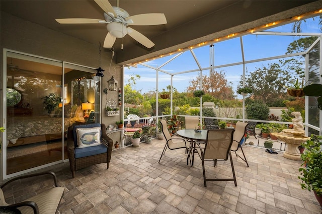 sunroom / solarium featuring ceiling fan