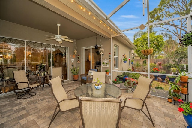 sunroom featuring ceiling fan