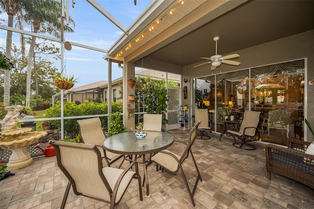 sunroom / solarium featuring ceiling fan