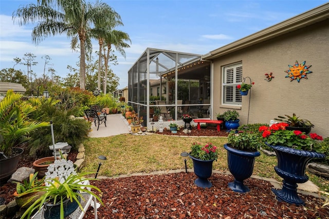 view of yard with a lanai and a patio area