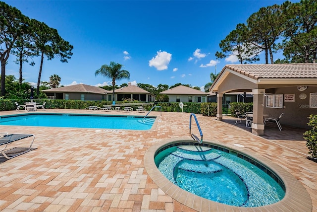 view of swimming pool with a patio and a community hot tub