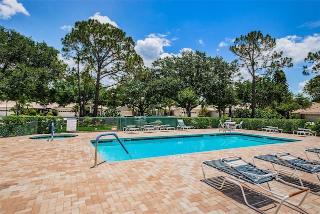 view of pool featuring a patio and a community hot tub