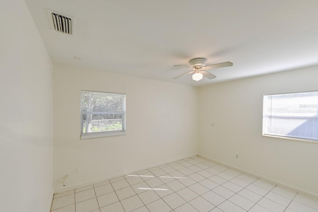 tiled spare room featuring ceiling fan