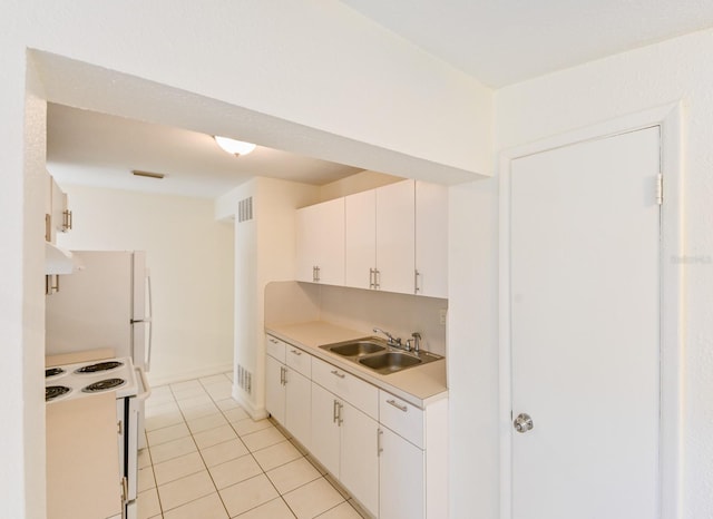 kitchen featuring light tile patterned flooring, white cabinetry, sink, and white appliances