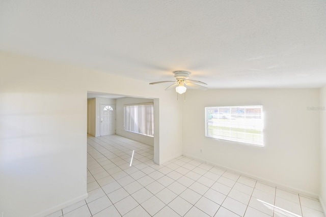 tiled spare room with ceiling fan