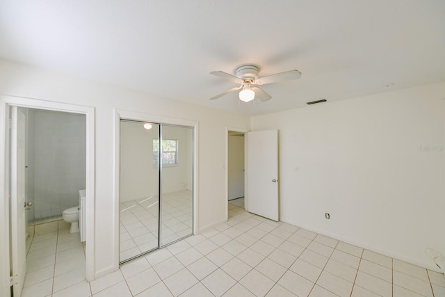 unfurnished bedroom featuring ceiling fan, connected bathroom, and light tile patterned floors