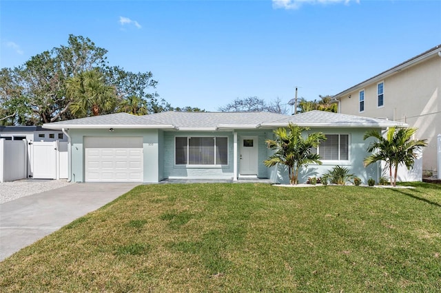 single story home featuring a front lawn and a garage