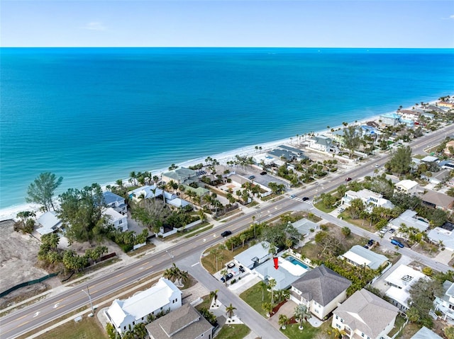 drone / aerial view with a beach view and a water view