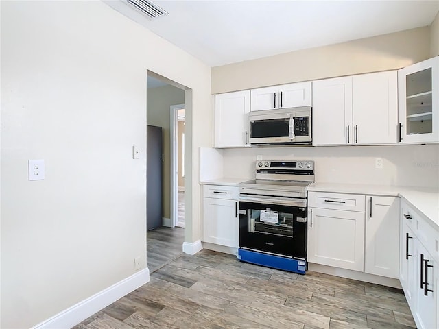 kitchen featuring white cabinetry, light hardwood / wood-style flooring, and stainless steel appliances