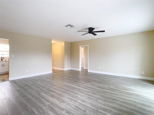 unfurnished room with ceiling fan and light wood-type flooring