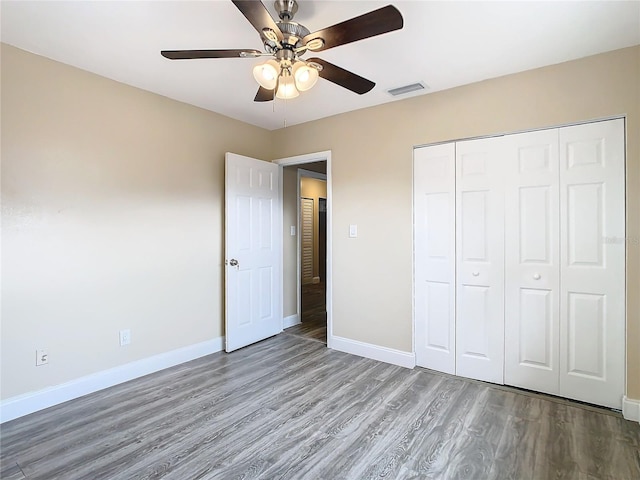 unfurnished bedroom with a closet, ceiling fan, and hardwood / wood-style floors