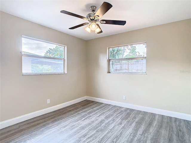 spare room with ceiling fan and wood-type flooring