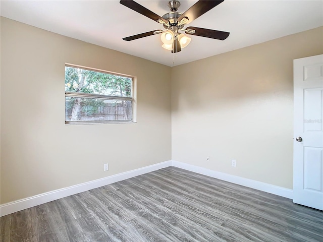 spare room featuring ceiling fan and dark hardwood / wood-style flooring