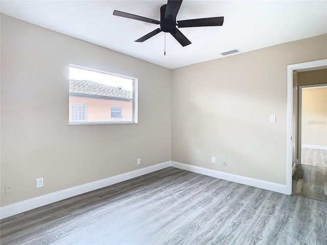 unfurnished room with ceiling fan and wood-type flooring