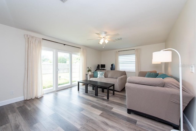 living room with ceiling fan and hardwood / wood-style floors