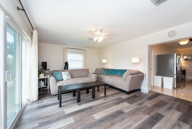 living room featuring light wood-type flooring and ceiling fan