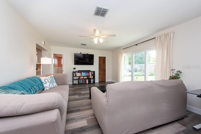 living room with ceiling fan and dark hardwood / wood-style floors