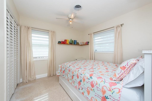 bedroom with ceiling fan and multiple windows