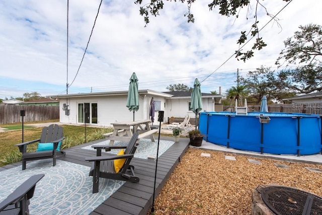 back of house with a swimming pool side deck