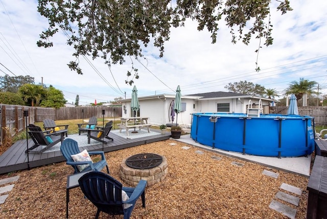 view of yard with an outdoor fire pit and a swimming pool side deck