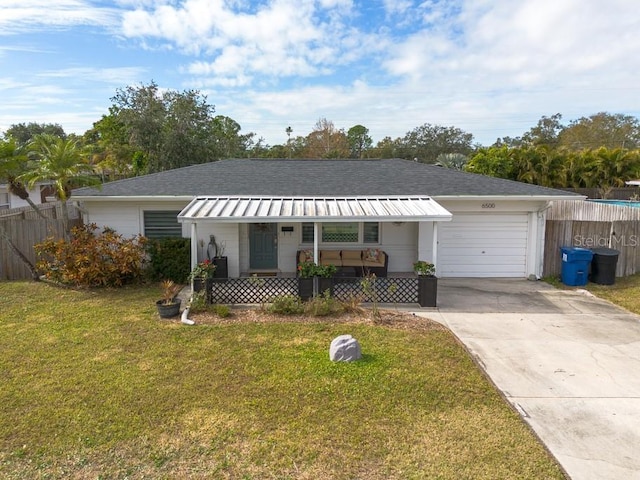 ranch-style house with covered porch, a front lawn, and a garage