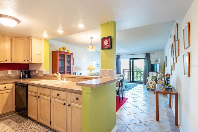 kitchen featuring dishwasher, sink, hanging light fixtures, kitchen peninsula, and light tile patterned flooring