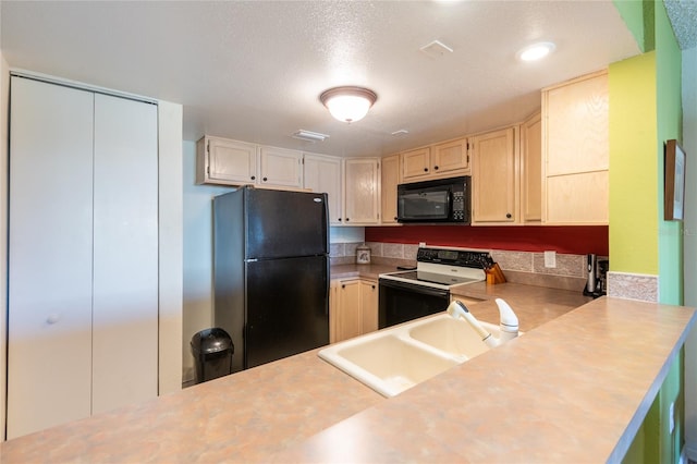 kitchen with sink, a textured ceiling, light brown cabinets, and black appliances