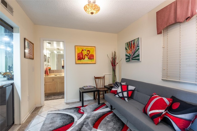 tiled living room with a textured ceiling