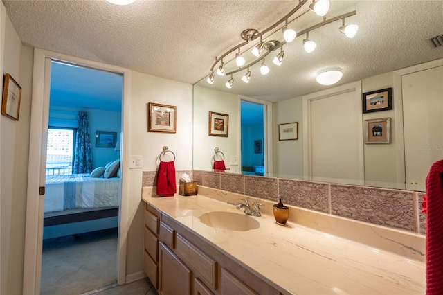 bathroom featuring a textured ceiling and vanity