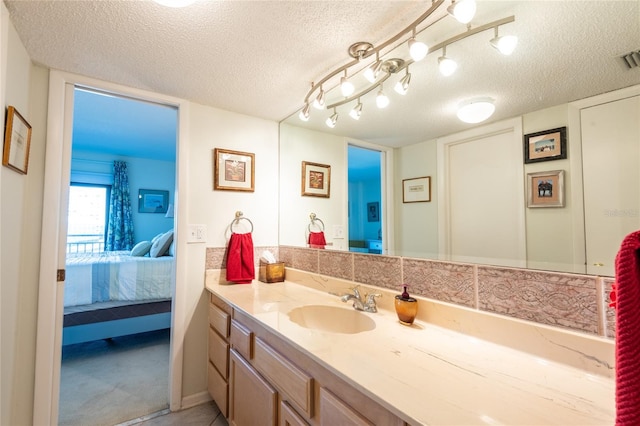 bathroom with vanity and a textured ceiling