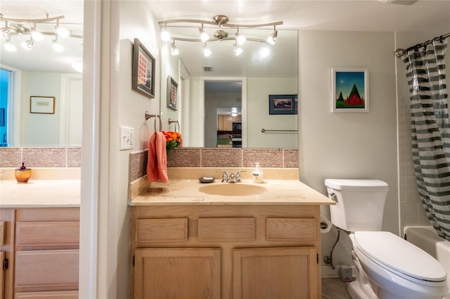 full bathroom featuring toilet, vanity, and shower / bath combo with shower curtain