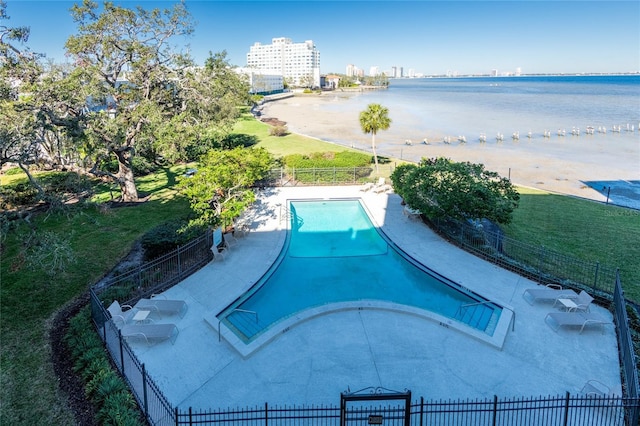 view of swimming pool with a patio area and a water view