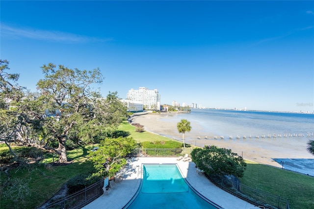 view of pool featuring a water view and a patio