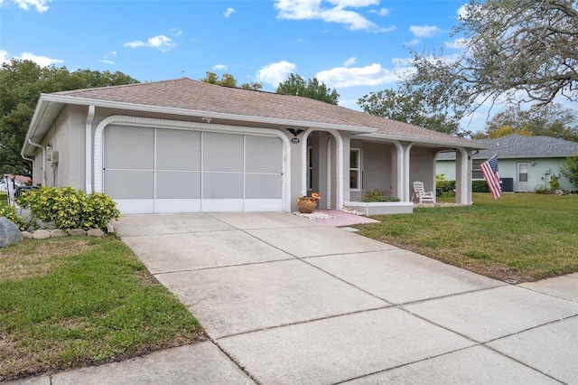 single story home featuring a garage, a front lawn, and a porch