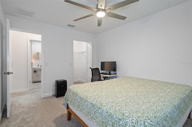 bedroom with a spacious closet, ceiling fan, carpet floors, a closet, and sink