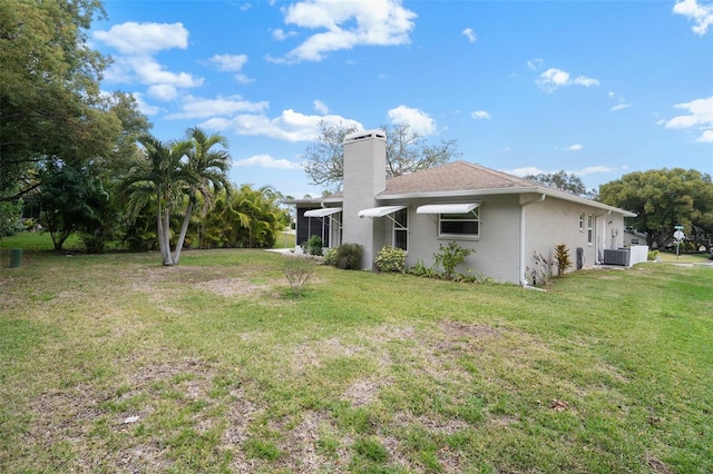 exterior space with a lawn and central AC unit